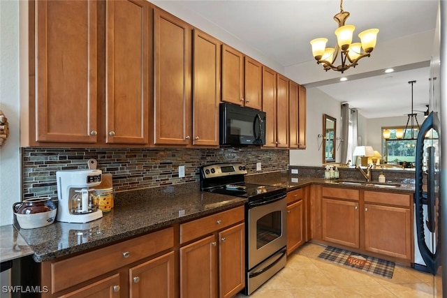 kitchen with dark stone countertops, a notable chandelier, stainless steel electric range oven, sink, and decorative light fixtures