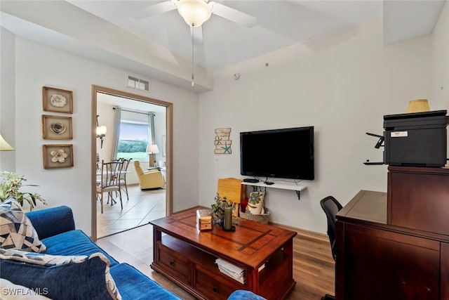 living room with ceiling fan and light hardwood / wood-style flooring