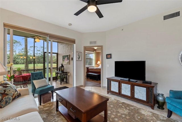 living room featuring ceiling fan and light tile patterned flooring