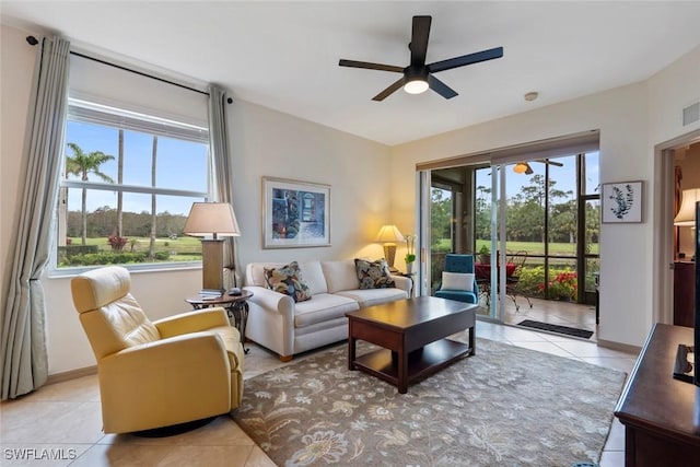 living room with light tile patterned floors, ceiling fan, and a wealth of natural light