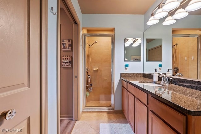 bathroom featuring vanity, tile patterned flooring, and a shower with shower door