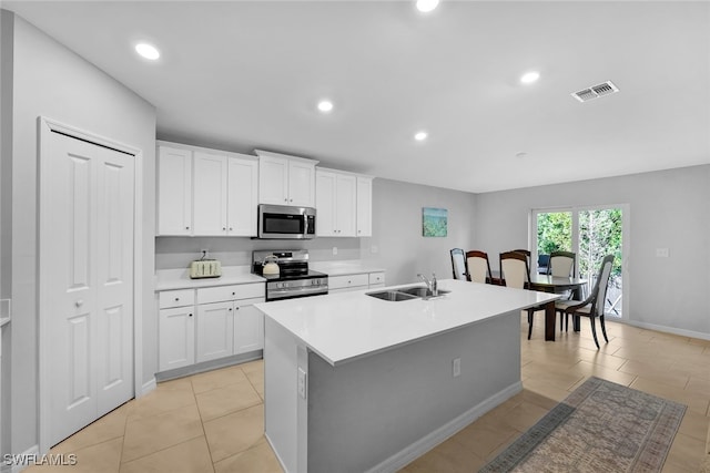 kitchen featuring sink, white cabinetry, an island with sink, and appliances with stainless steel finishes