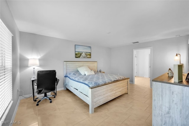 bedroom with light tile patterned floors