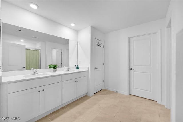 bathroom with tile patterned flooring and vanity