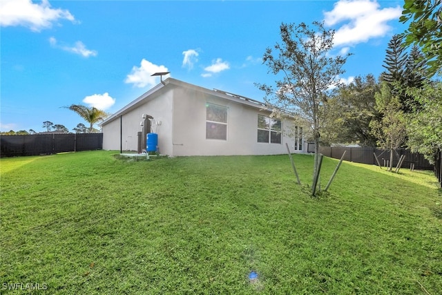 back of house with a lawn