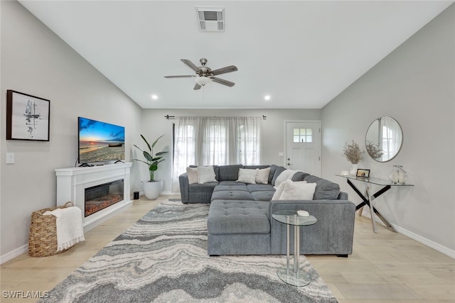 living room with ceiling fan and light hardwood / wood-style flooring