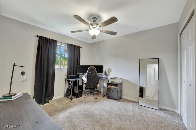 home office featuring ceiling fan and light carpet