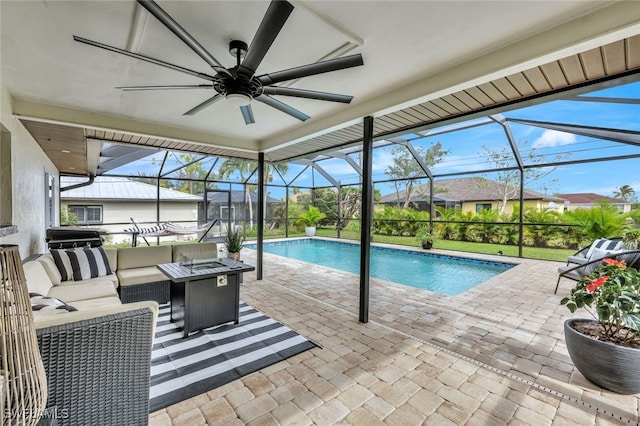 view of pool featuring a lanai, an outdoor living space with a fire pit, ceiling fan, and a patio area