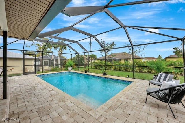 view of swimming pool with a lanai, a patio area, a lawn, and outdoor lounge area