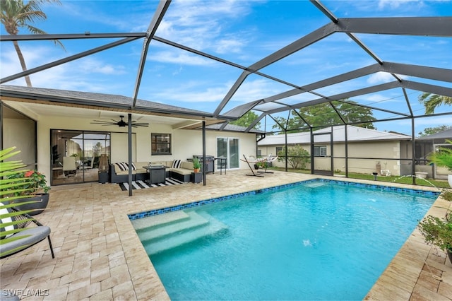 view of swimming pool with a lanai, ceiling fan, outdoor lounge area, and a patio area