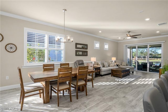 dining space with ceiling fan with notable chandelier and ornamental molding