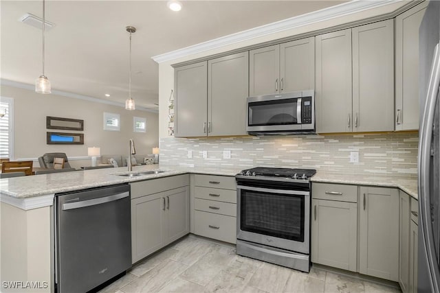 kitchen featuring gray cabinetry, stainless steel appliances, a peninsula, a sink, and pendant lighting