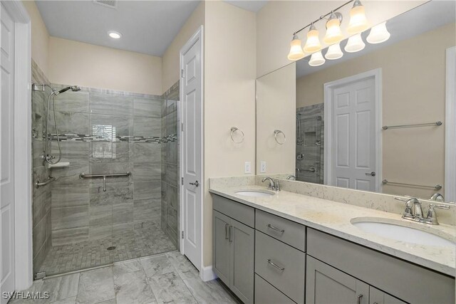 bathroom with a shower with door and vanity