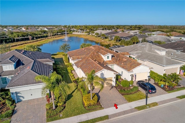 drone / aerial view featuring a residential view and a water view