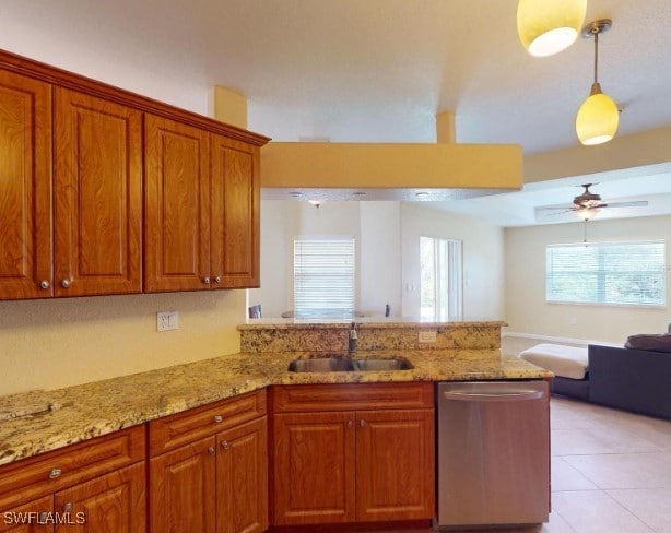 kitchen featuring kitchen peninsula, dishwasher, hanging light fixtures, and sink