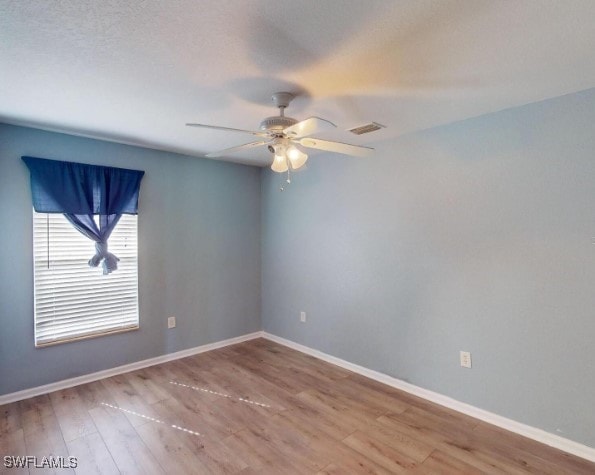 empty room featuring ceiling fan and wood-type flooring