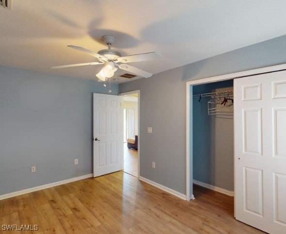 unfurnished bedroom with a closet, light hardwood / wood-style flooring, and ceiling fan