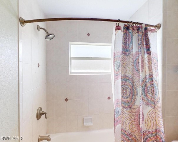 bathroom with shower / bath combination with curtain