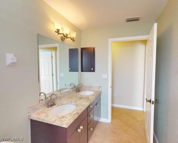 bathroom with tile patterned flooring and vanity