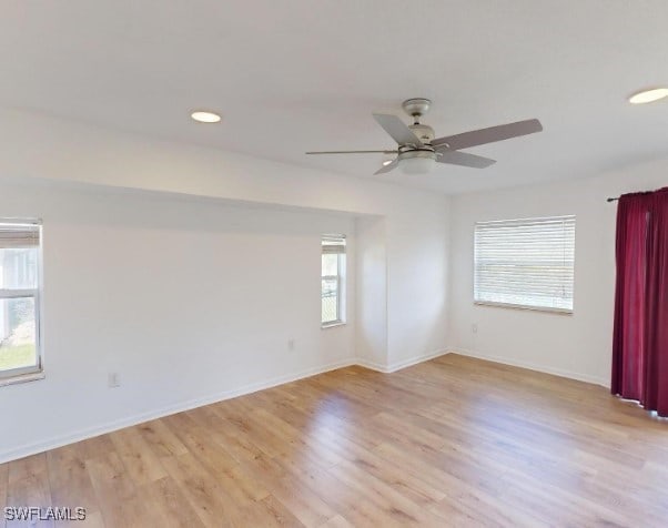 spare room with ceiling fan and light hardwood / wood-style flooring