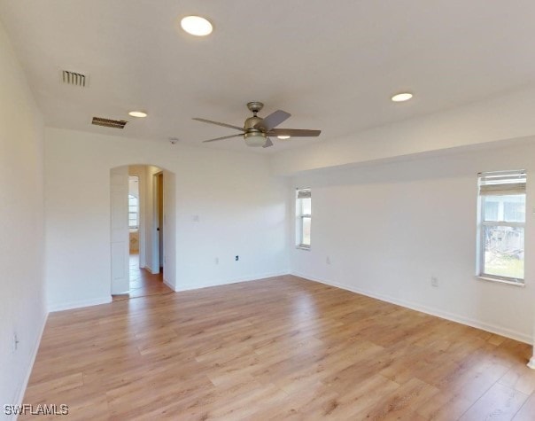 empty room with ceiling fan and light wood-type flooring