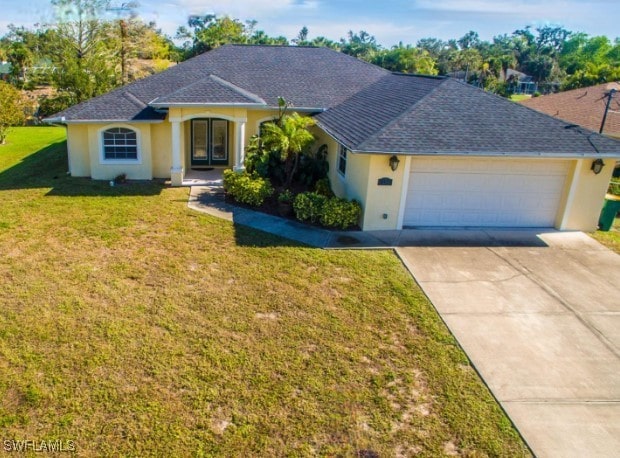 ranch-style house featuring a garage and a front yard