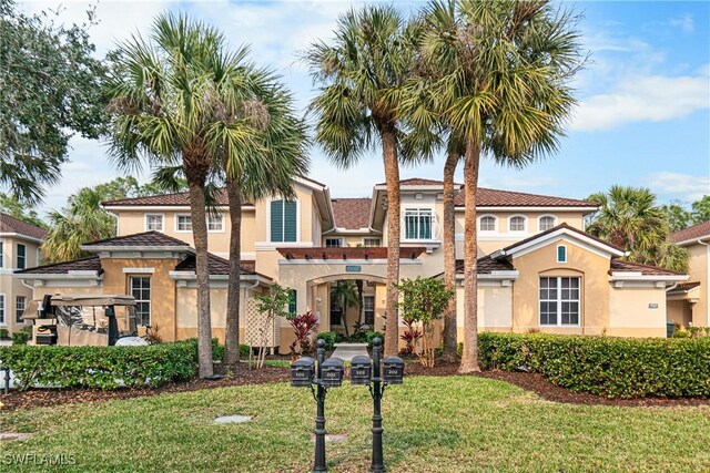 mediterranean / spanish house with a front yard