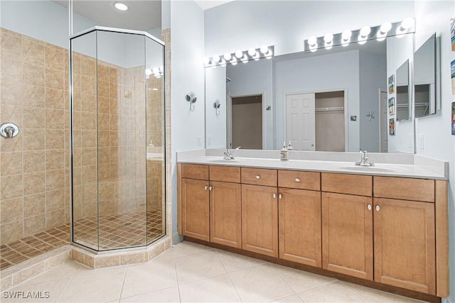 bathroom with tile patterned flooring, vanity, and a shower with shower door