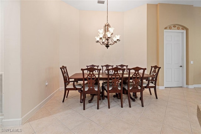 tiled dining room featuring a notable chandelier