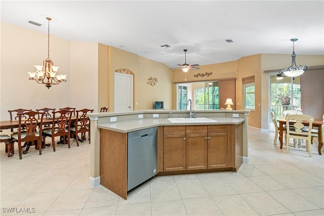 kitchen with pendant lighting, sink, an island with sink, ceiling fan with notable chandelier, and stainless steel dishwasher