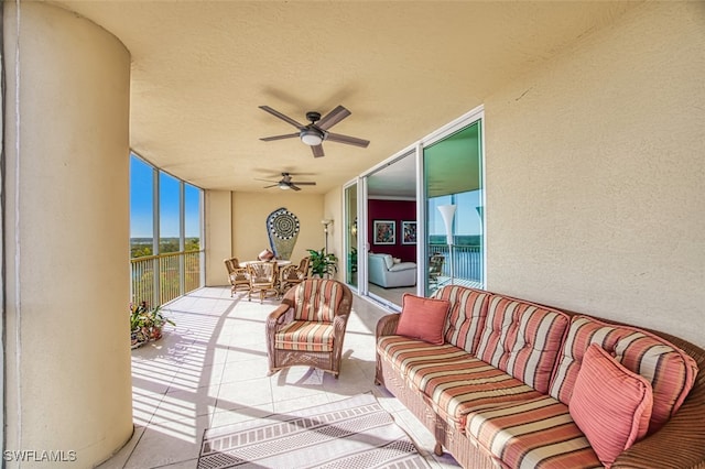 view of patio / terrace with a balcony and ceiling fan