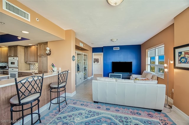 living room with light tile patterned flooring