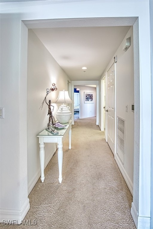 hall featuring light colored carpet