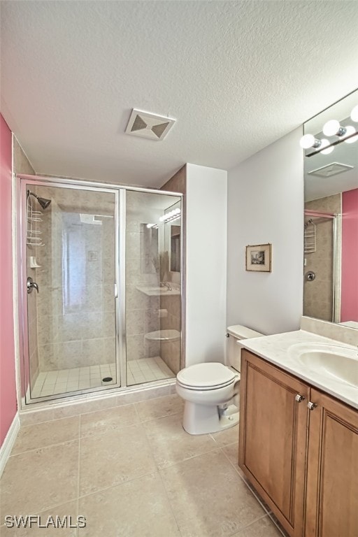 bathroom featuring walk in shower, vanity, toilet, and a textured ceiling