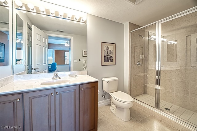 bathroom featuring walk in shower, vanity, toilet, and a textured ceiling