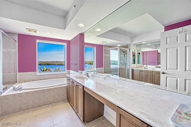 bathroom featuring vanity, separate shower and tub, a healthy amount of sunlight, and tile patterned floors