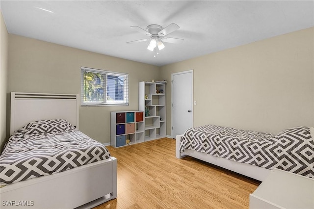 bedroom with ceiling fan and light wood-type flooring