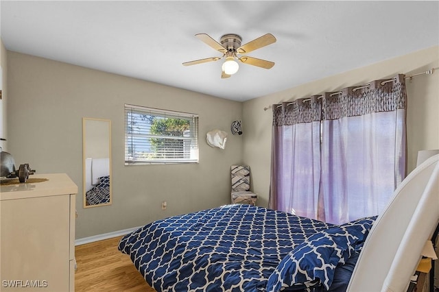 bedroom featuring ceiling fan and light hardwood / wood-style flooring