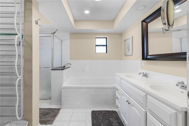 bathroom featuring tile patterned floors, radiator, vanity, a tray ceiling, and independent shower and bath