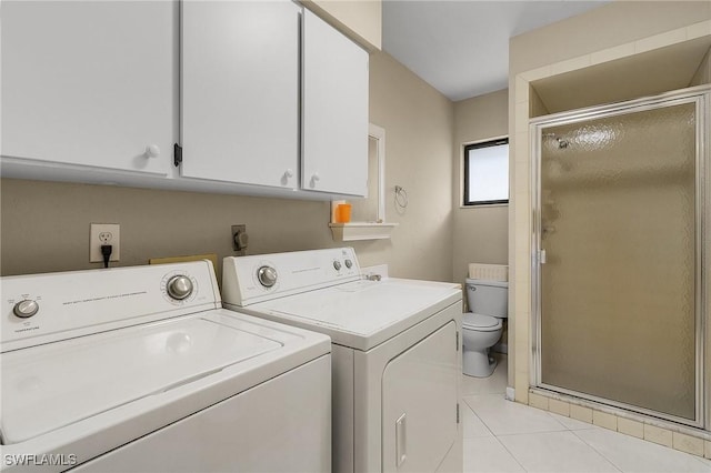 clothes washing area with washer and clothes dryer and light tile patterned floors