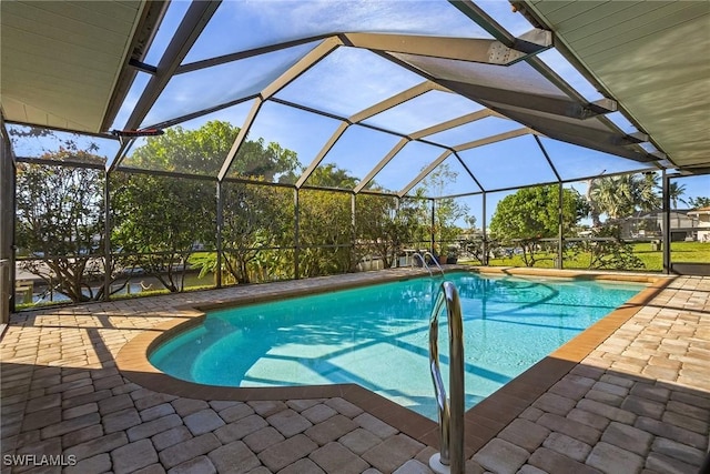 view of swimming pool with a lanai and a patio area