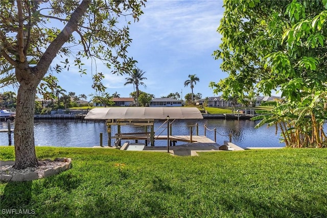 dock area with a yard and a water view