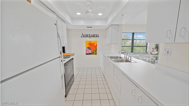 kitchen with sink, white cabinets, white fridge, black electric range oven, and light tile patterned floors