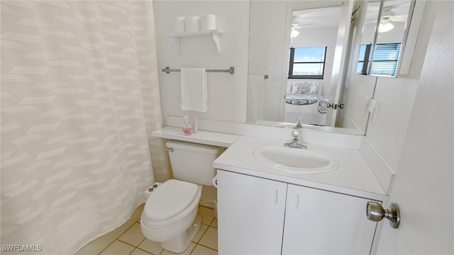 bathroom featuring tile patterned flooring, vanity, and toilet