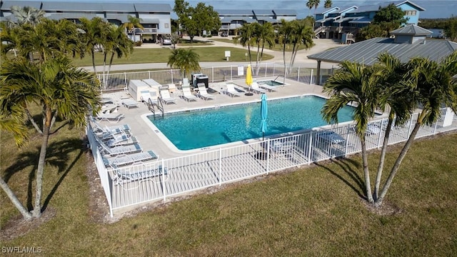 view of pool featuring a patio area and a lawn