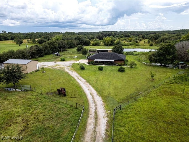 birds eye view of property featuring a water view and a rural view