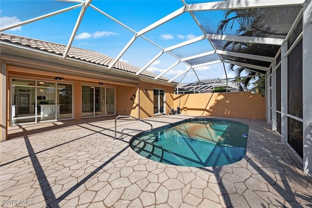 view of swimming pool featuring a lanai and a patio area