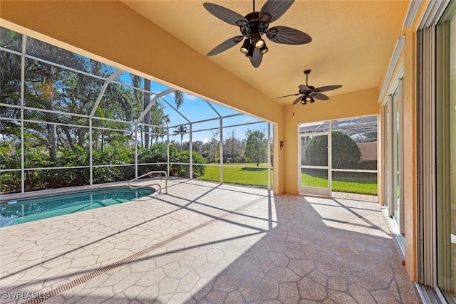 unfurnished sunroom featuring ceiling fan and a pool