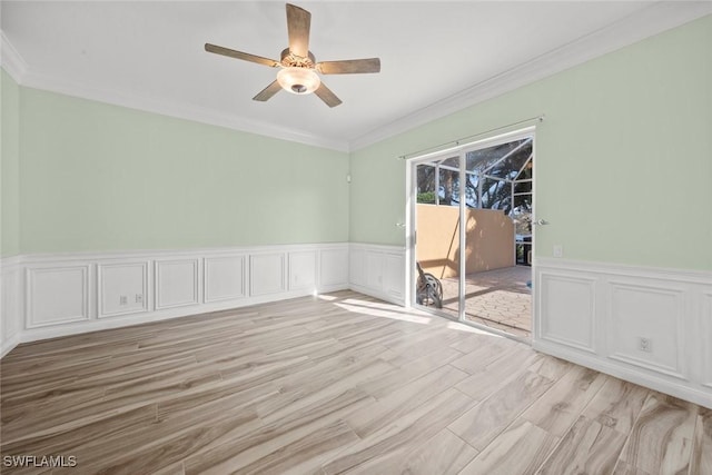 empty room with ceiling fan, ornamental molding, and light hardwood / wood-style floors