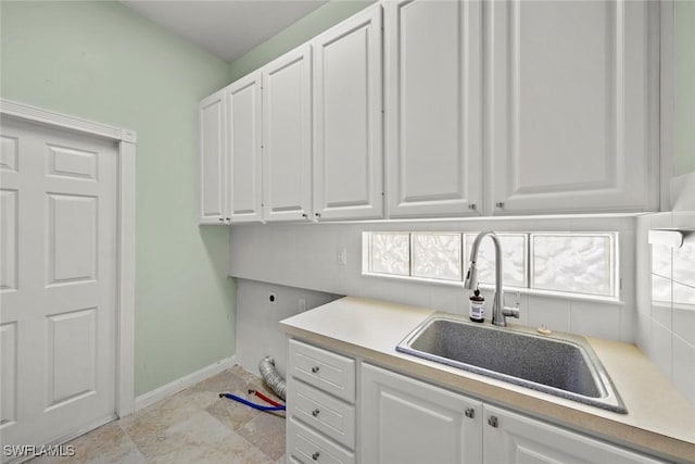 washroom featuring cabinets, sink, and hookup for an electric dryer